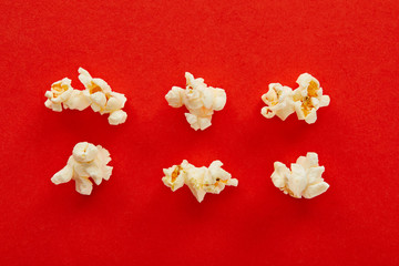 Obraz na płótnie Canvas flat lay with sweet popcorn on red background