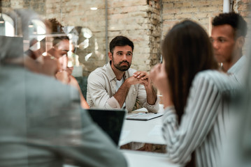 Brainstorming. Business people discussing something and working together while sitting at the...