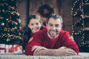 Close-up portrait of two nice attractive lovely charming cute idyllic cheerful cheery peaceful family daddy dad lying on comfortable carpet spending vacation industrial loft wood brick style interior