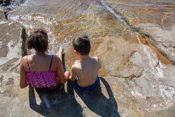 young couple, boy and girl, brother and sister, on the beach