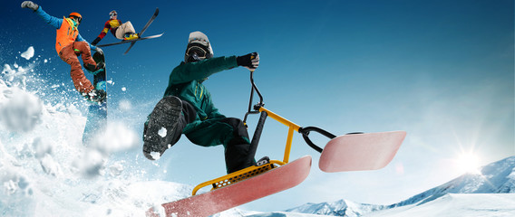 Skiing, snow scoot, snowboarding.  Extreme winter sports.
