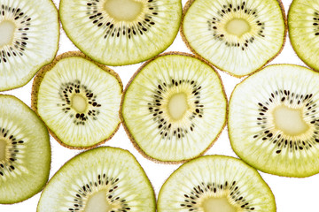 Macro photo of a beautiful delicious kiwi sliced in circles with back light on the lumen. Top view