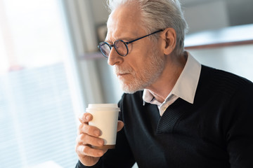 Senior man holding a coffee cup