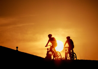 Fototapeta na wymiar silhouette of cyclist on background of sunset