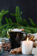 1 mug with hot chocolate and marshmallows, cinnamon stick and Lollipop, candle, fir branch