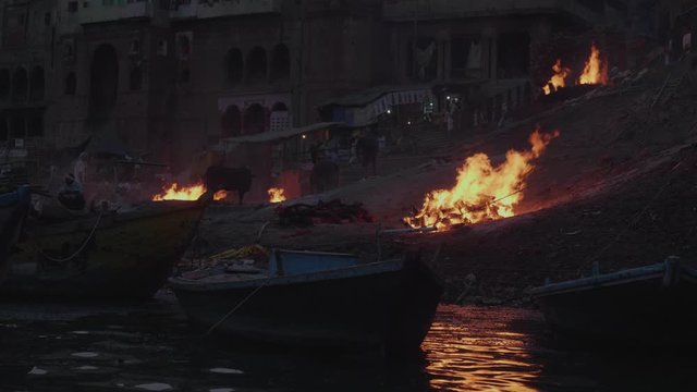 Boat In The Ganges River Viewing The Famous Cremation Burning Ceremony At The Ghats in Varanasi India