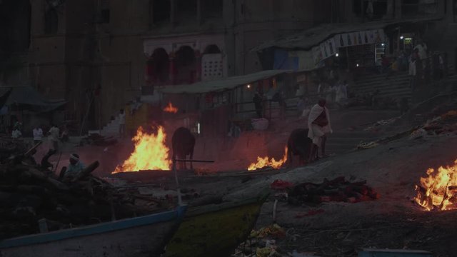 Boat In The Ganges River Viewing The Famous Cremation Burning Ceremony At The Ghats in Varanasi India