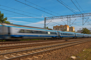 Obraz na płótnie Canvas Speeding Train on suburban rails