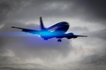 Fototapeta na wymiar plane in the sky motion blur with blue light flare