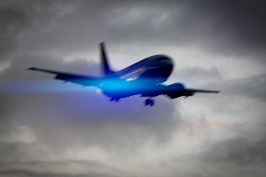 plane in the sky motion blur with blue light flare