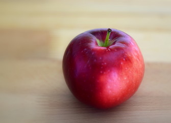 red apple on wooden table