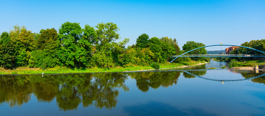 Blue metal bridge with rat, over river Weser. Hameln, Germany