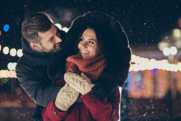 Photo of two people spend x-mas evening near central park tree embracing piggyback wearing warm winter jackets enjoy best company outside