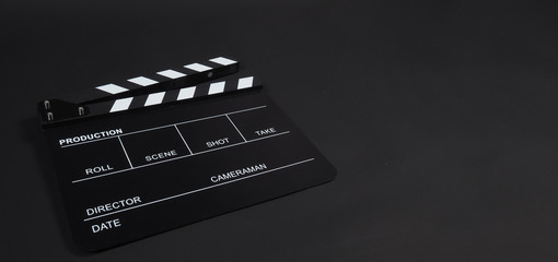 Fototapeta na wymiar Clapperboard or clap board or movie slate use in video production ,film, cinema industry on black background.