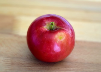 red apple on wooden table