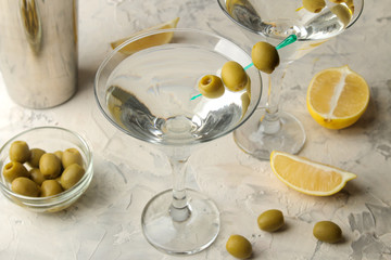 Martini. Alcoholic drink martini with olives in a glass on a light background in the bar on the bar counter. bar inventory. cocktails