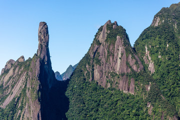 Fototapeta premium Postcard trail view where you can observe in detail de vegetation and topography of the to Serra dos Orgãos (Organs Mountain) with Finger's God highlighted in landscape.