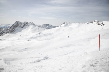 Snow slopes with snow-covered mountains in the background