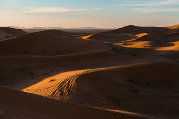 Naklejka na ściany i meble Gorgeous and scenic desert sunset scene above beautiful sand dunes Erg Chebbi, Morocco, Merzouga