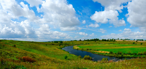 Fototapeta na wymiar Beautiful panoramic landscape with river and green fields