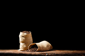 Fresh coffee grains in brown sack and free space for your decoration. 