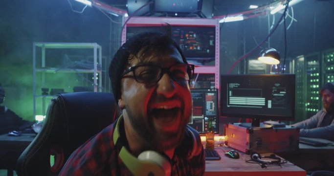 Hacker laughing then glaring into camera