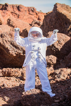 Astronaut spaceman Standing on the Rocky Mountain of the Alien Red   Planet/ Mars. First Manned Mission on Mars. Space Exploration,   Colonization.