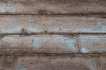 Old weatherd wood retro grunge background with blue painted planks peeling left over due to age.