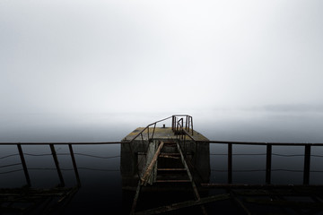 Damaged pier in the mist at morning