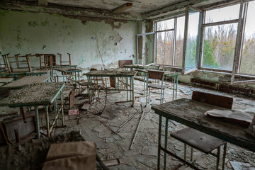 Fototapeta na wymiar Messy and abandoned classroom in ghost town