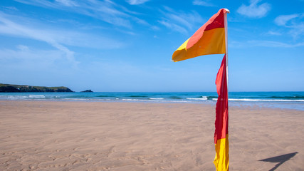 yellow/red beach flag on beach