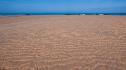 Fototapeta na wymiar waves in the sand on the beach