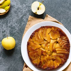 Pear pie on a gray stone. Homemade cake. Gray background. Delicious dessert on a white plate. Food photography. Flan