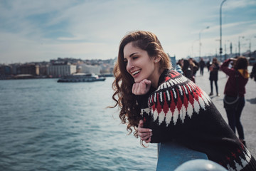 Young smiling tourist woman on Galata bridge