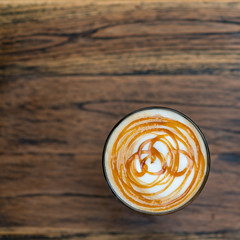 Top view of hot mocha coffee in a glass on wooden table. A caffè mocha, also called mocaccino is a chocolate-flavored variant of a caffè latte.