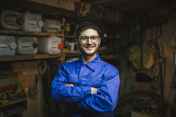 Portrait of a smiling man in his workshop.