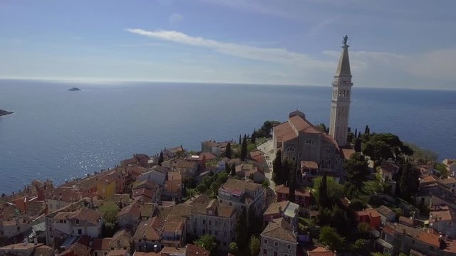Aerial view of Rovini. An old historic European city with a church and the sea in the background.