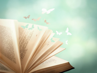 Open magic book with magic paper butterflies fly from it