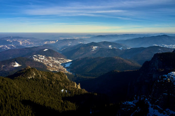 Aerial Landscape view from Ceahlău Mountains National Park at sunrise in winter season