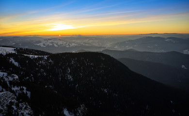 Aerial Landscape view from Ceahlău Mountains National Park at sunrise with fog in the winter season,sunrise in Ceahlau Mountains