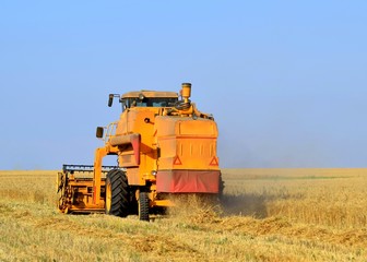 combine harvester working on wheat field