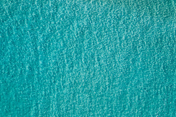 Obraz na płótnie Canvas Blue water background photo of ocean from drone