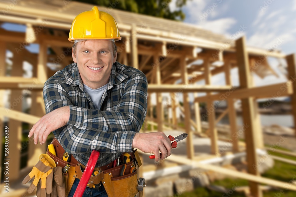 Wall mural Male worker with tool belt isolated on   background