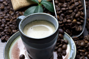 A cup of coffee with coffee bean as background