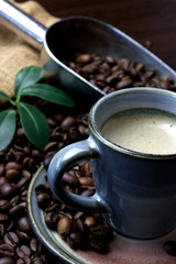 A cup of coffee with coffee bean as background