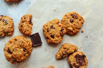 Oatmeal cookies with chocolate. Cookies on a light background with parchment.