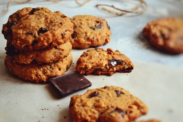 Oat cookies. Cookies on a light background with parchment. Sweet pastries with an autumn theme and autumn yellow leaves. Autumn appetizing background.