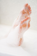 Woman legs in bath with milk. SPA treatments for skin care.