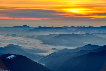 Fototapeta na wymiar Amazing sunrise view from Ceahlău Mountains National in winter season, Winter Landscape in National Park Ceahlau
