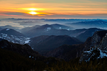 Obraz premium Aerial Landscape view from Ceahlău Mountains National Park at sunset in winter season,Sunset in Ceahlau Mountains